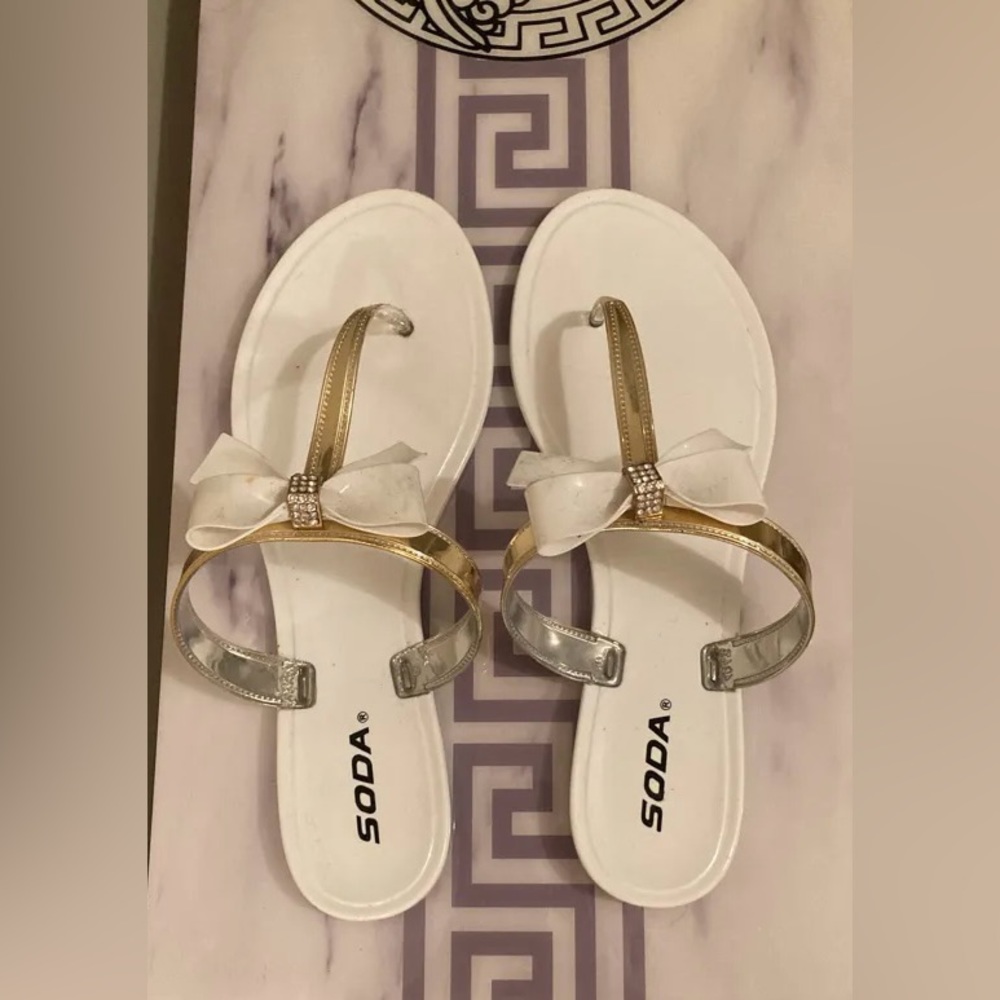 White and gold flip flops